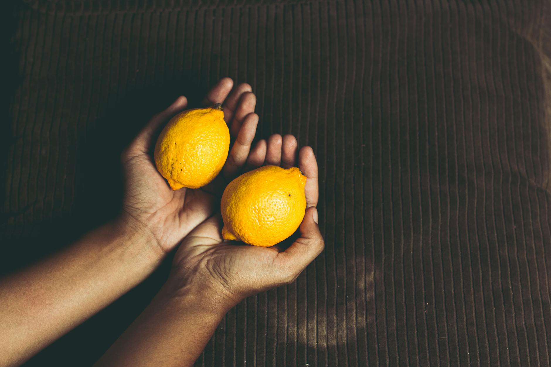 Fresh lemons held in cupped hands, symbolizing renewal and sensitivity restoration