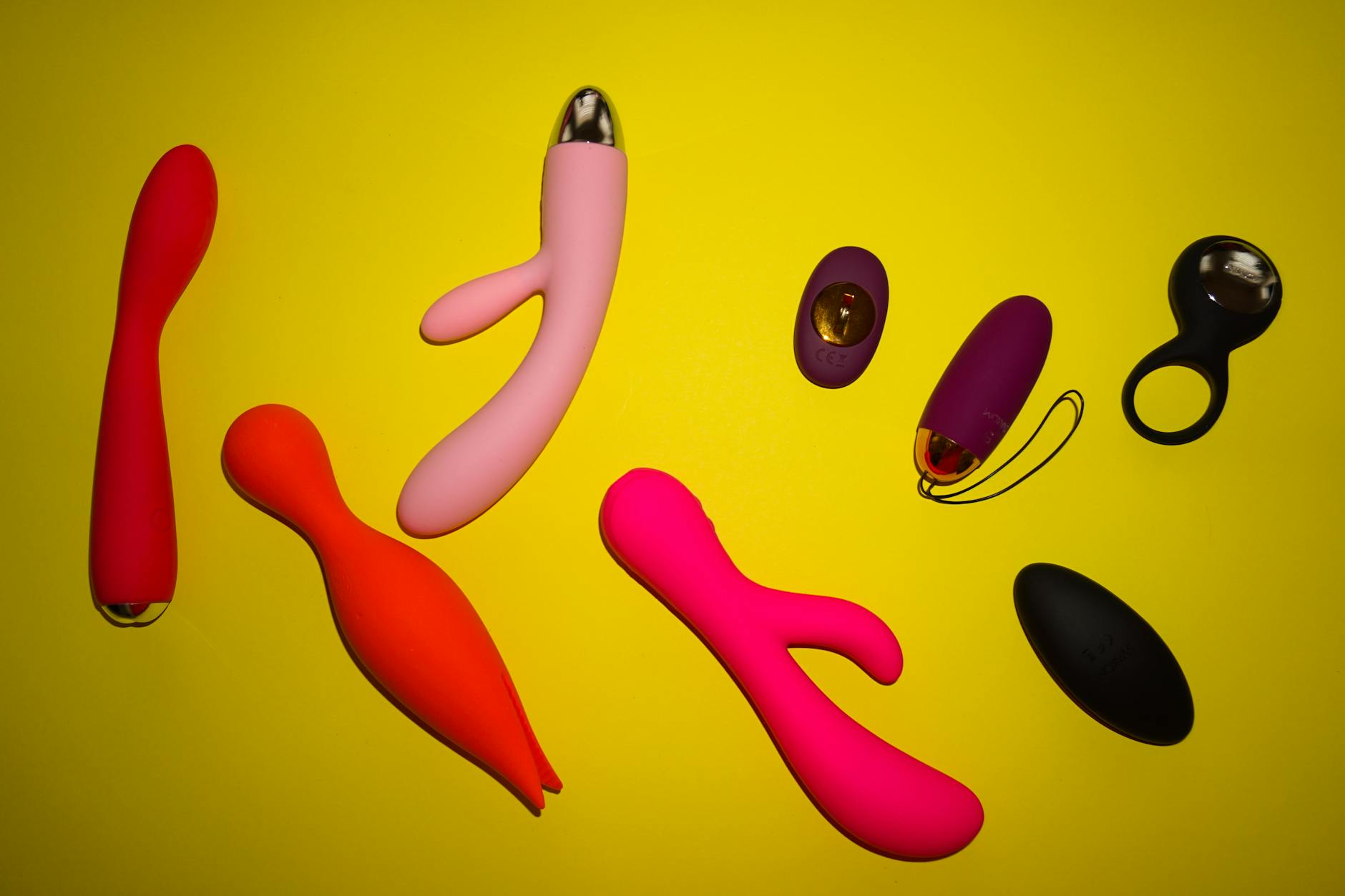A young couple standing together indoors, holding a vibrator, symbolizing modern intimacy and partnership.