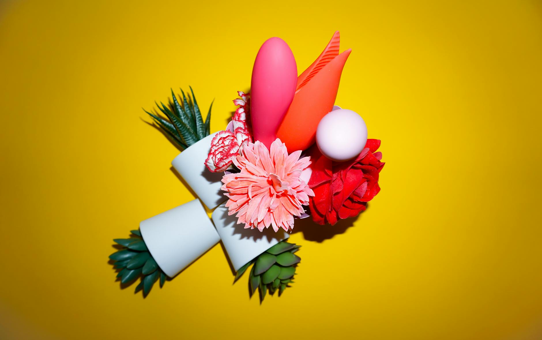 A hand holding a lemon on a soft pink background, representing freshness and new beginnings after relationship change